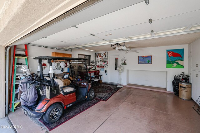 garage with a garage door opener and ceiling fan