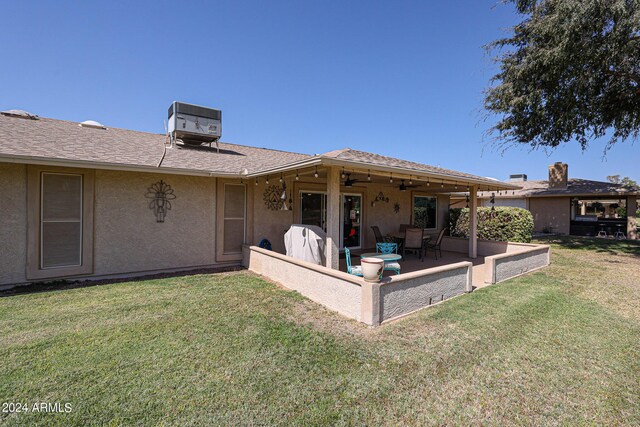 back of property with ceiling fan, a yard, a patio area, and central air condition unit