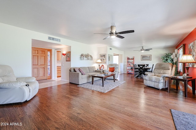 living room with ceiling fan and hardwood / wood-style flooring