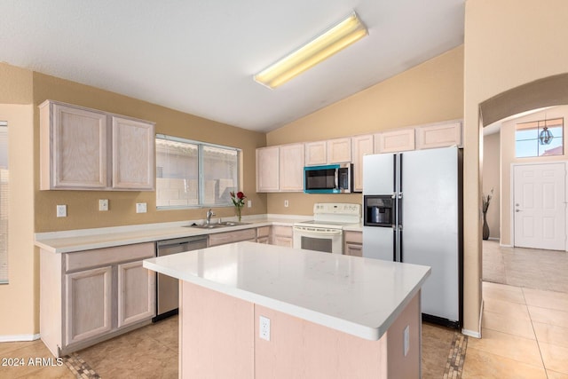 kitchen featuring sink, a center island, lofted ceiling, light tile patterned flooring, and appliances with stainless steel finishes