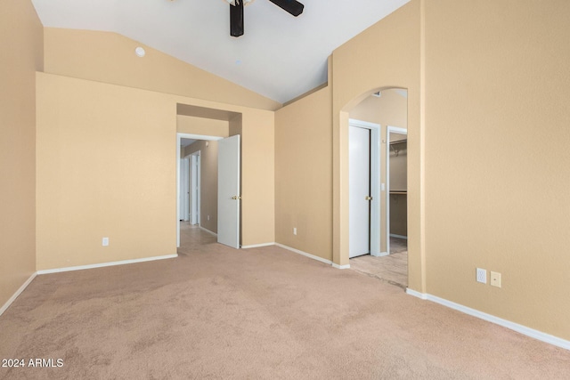 empty room with light carpet, ceiling fan, and lofted ceiling