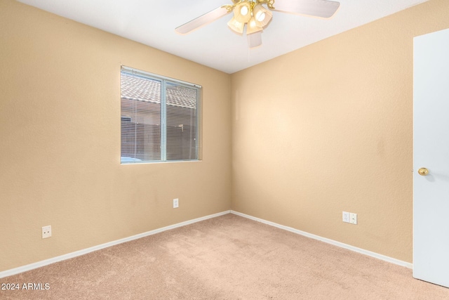 unfurnished room featuring ceiling fan and light carpet