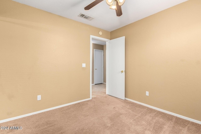 carpeted spare room with ceiling fan