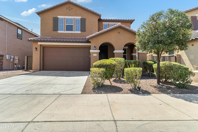 21243 W Coronado Rd, Buckeye, AZ 85396 - view of front facade with a tile roof, concrete driveway, stucco siding, and a garage