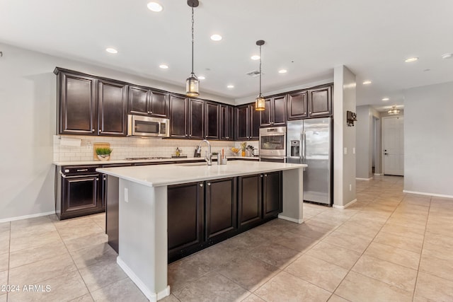 21243 W Coronado Rd, Buckeye, AZ 85396 - kitchen featuring light countertops, decorative backsplash, a sink, dark brown cabinetry, and appliances with stainless steel finishes
