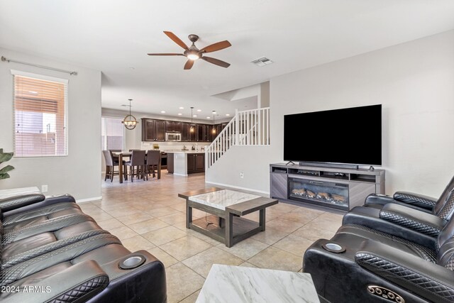 tiled living room featuring ceiling fan