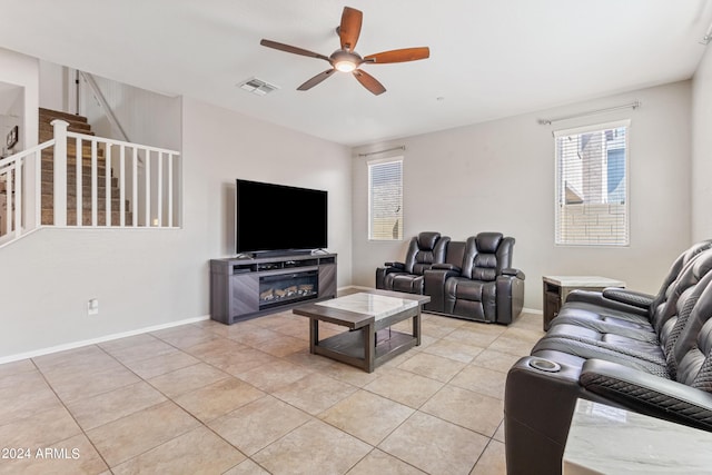 21243 W Coronado Rd, Buckeye, AZ 85396 - living room featuring visible vents, baseboards, stairs, ceiling fan, and light tile patterned floors