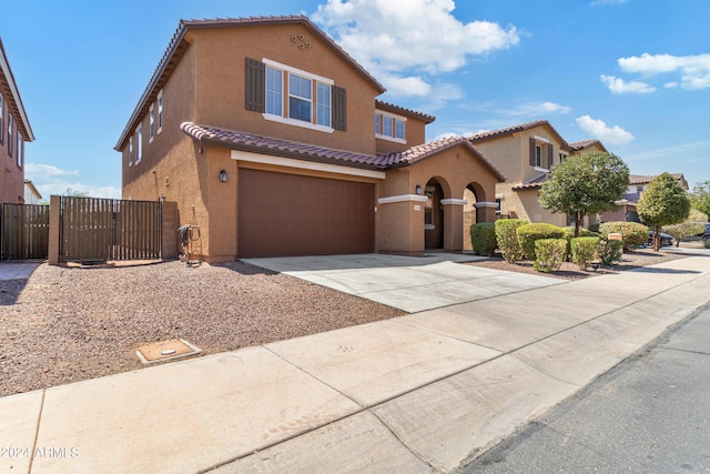 21243 W Coronado Rd, Buckeye, AZ 85396 - mediterranean / spanish-style house featuring a tiled roof, stucco siding, and an attached garage