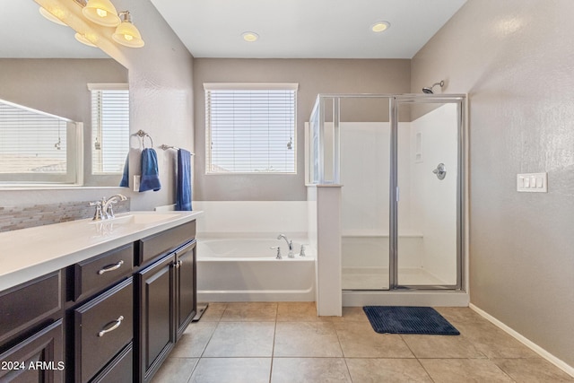 21243 W Coronado Rd, Buckeye, AZ 85396 - bathroom featuring tile patterned floors, vanity, a stall shower, and a bath
