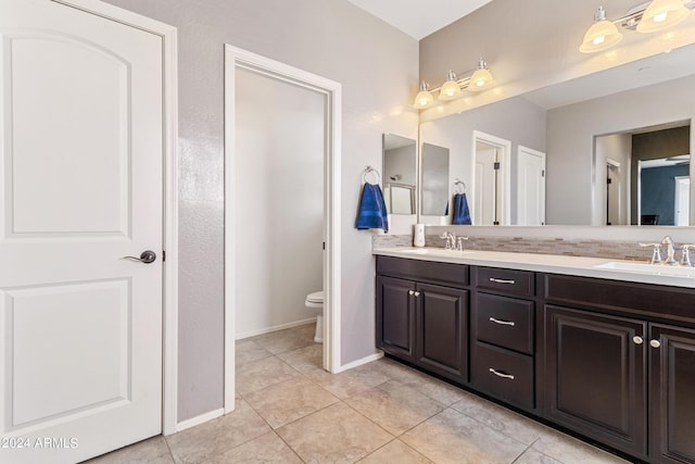 21243 W Coronado Rd, Buckeye, AZ 85396 - bathroom featuring double vanity, a sink, toilet, and tile patterned floors