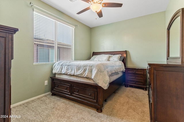 bedroom featuring ceiling fan and light carpet