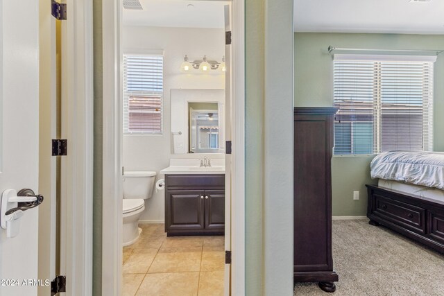 bathroom featuring vanity, toilet, and tile patterned floors