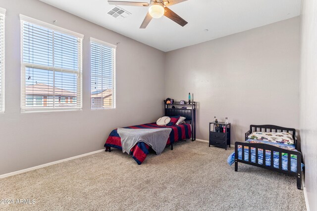 carpeted bedroom featuring ceiling fan