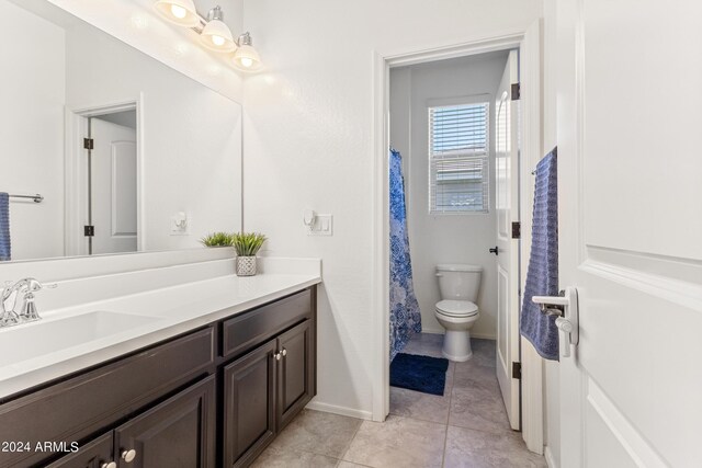 bathroom with vanity, toilet, and tile patterned floors