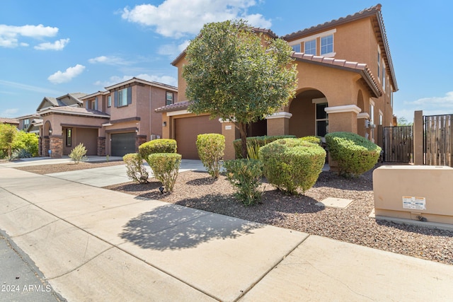 21243 W Coronado Rd, Buckeye, AZ 85396 - view of front of property featuring driveway, fence, a tiled roof, a garage, and stucco siding