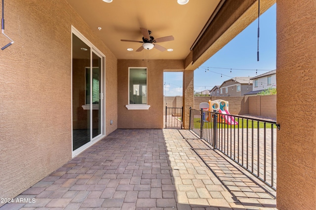 21243 W Coronado Rd, Buckeye, AZ 85396 - view of patio with a fenced backyard, a ceiling fan, and a playground