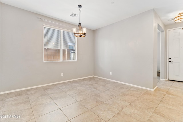 21243 W Coronado Rd, Buckeye, AZ 85396 - unfurnished room with light tile patterned floors, a notable chandelier, baseboards, and visible vents
