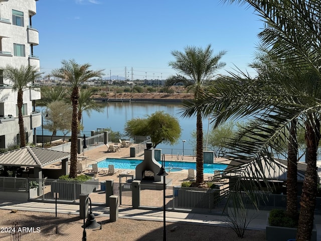 view of pool with a patio area and a water view