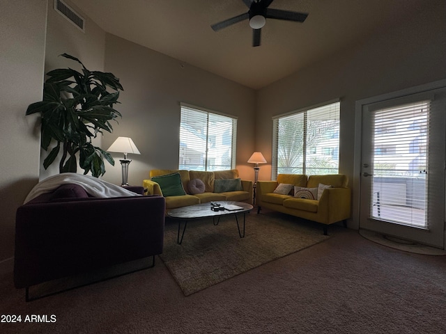 living room with carpet floors, vaulted ceiling, and ceiling fan