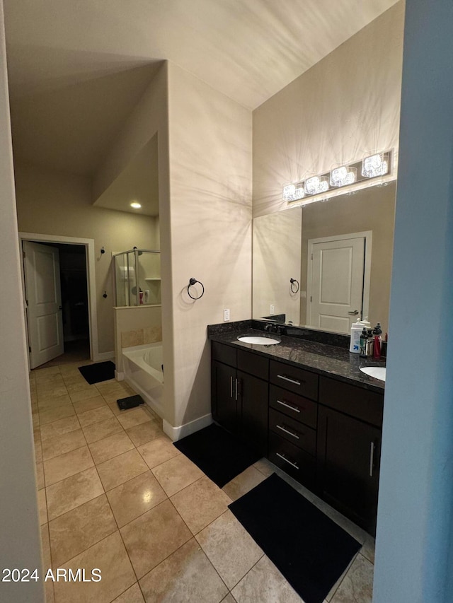 bathroom featuring tile patterned flooring, vanity, and separate shower and tub