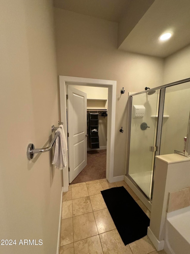 bathroom with tile patterned flooring and an enclosed shower