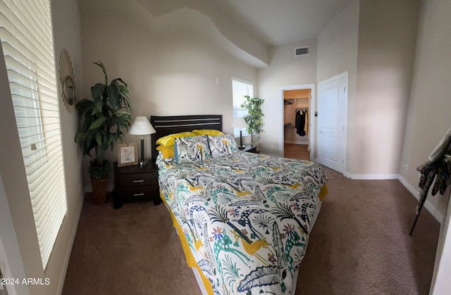 bedroom featuring dark carpet