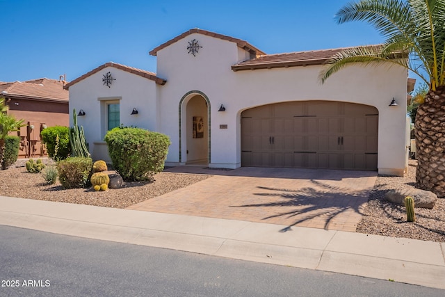 1787 E Sattoo Way, Queen Creek, AZ 85140 - mediterranean / spanish home with a tiled roof, an attached garage, decorative driveway, and stucco siding