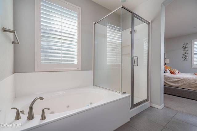 bathroom with tile patterned floors, a healthy amount of sunlight, and independent shower and bath