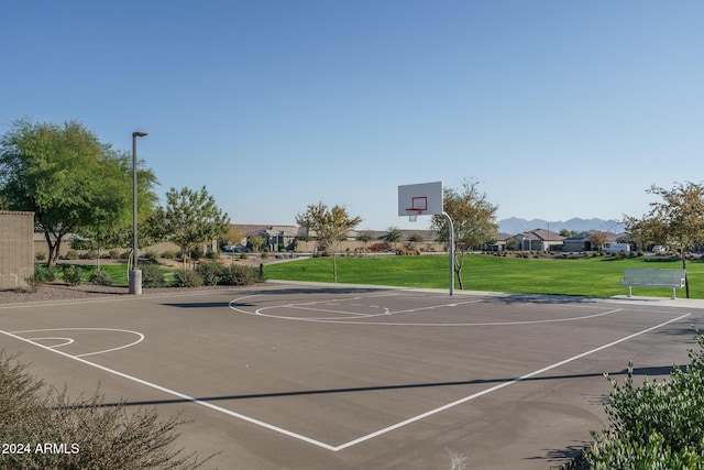 view of sport court featuring a lawn