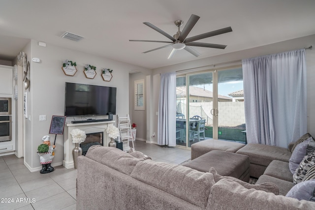 living room featuring ceiling fan and light tile patterned flooring