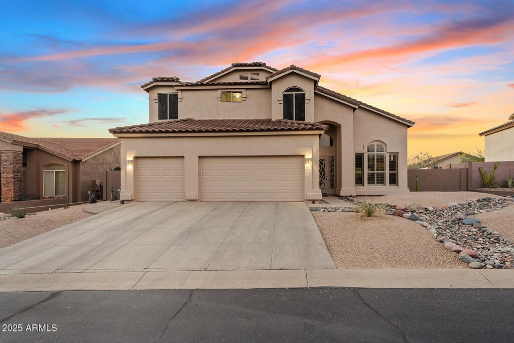 3060 N Ridgecrest Unit 172, Mesa, AZ 85207 - mediterranean / spanish-style house featuring an attached garage, stucco siding, fence, and a tile roof