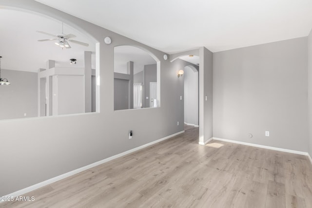 empty room featuring light hardwood / wood-style floors, ceiling fan, and lofted ceiling