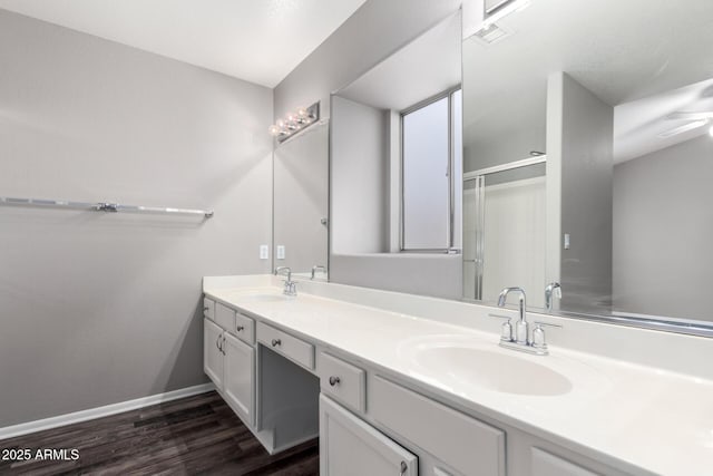 bathroom with ceiling fan, vanity, an enclosed shower, and hardwood / wood-style flooring