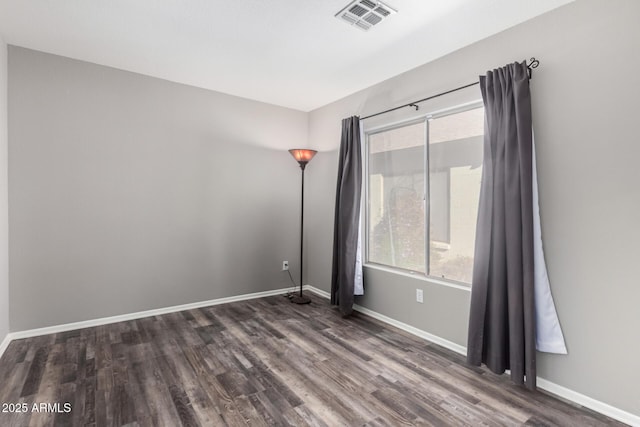 spare room featuring dark hardwood / wood-style flooring