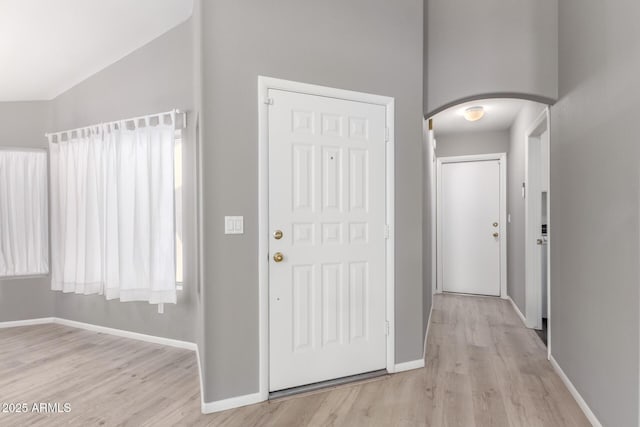 entryway featuring light wood-type flooring and lofted ceiling