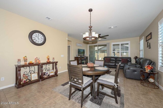 tiled dining room with ceiling fan