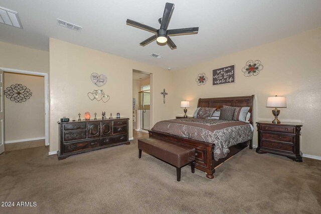 carpeted bedroom with ceiling fan and ensuite bathroom