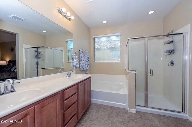 bathroom with tile patterned flooring, vanity, and plus walk in shower