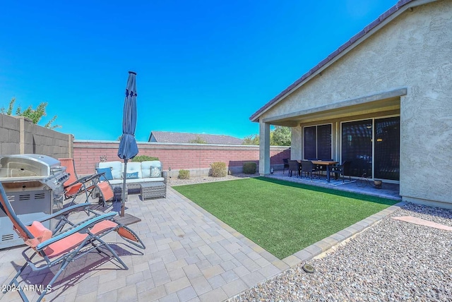 view of yard with outdoor lounge area and a patio