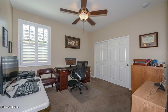 office featuring dark colored carpet and ceiling fan