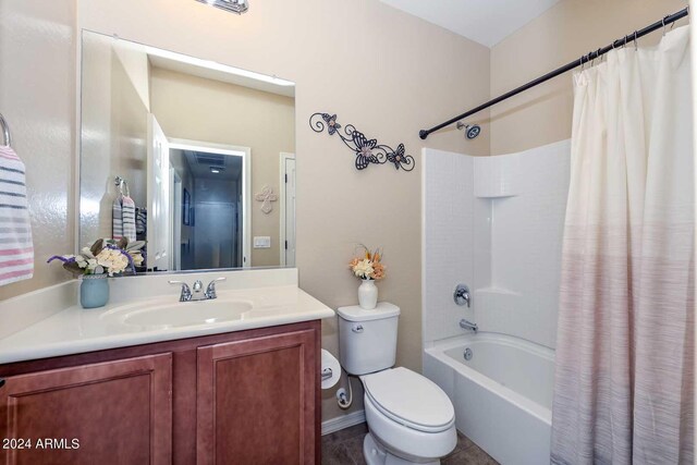 full bathroom with vanity, shower / bath combo with shower curtain, toilet, and tile patterned flooring