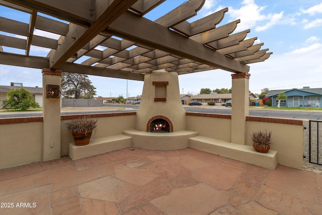 view of patio featuring a large fireplace and a pergola