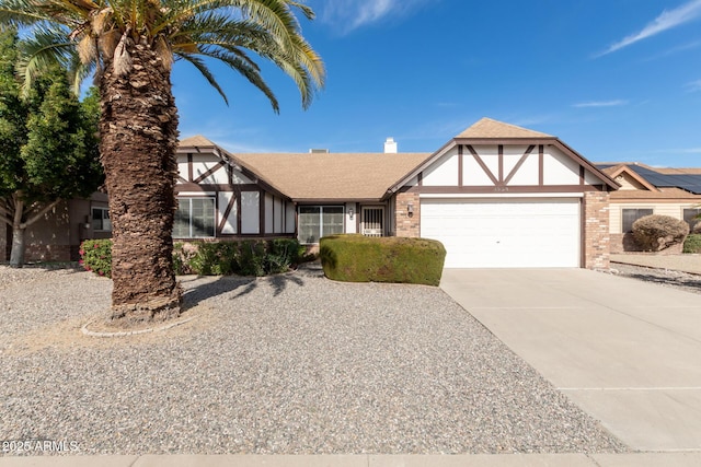 tudor house featuring a garage