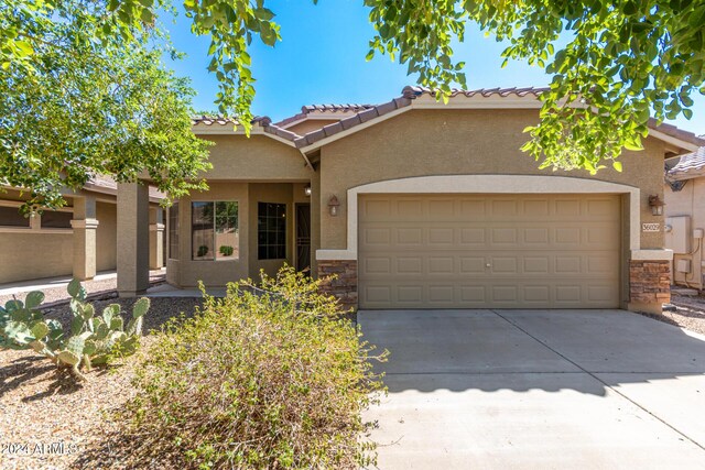 obstructed view of property with a garage