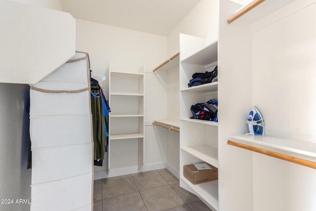 spacious closet featuring light tile patterned flooring