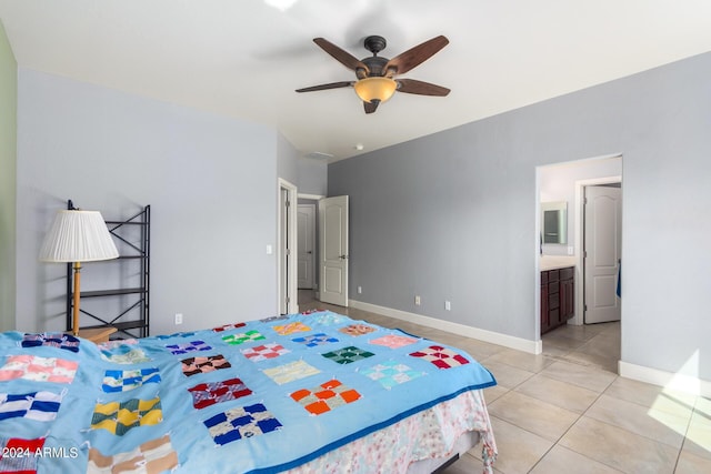 bedroom with light tile patterned floors, connected bathroom, a ceiling fan, and baseboards