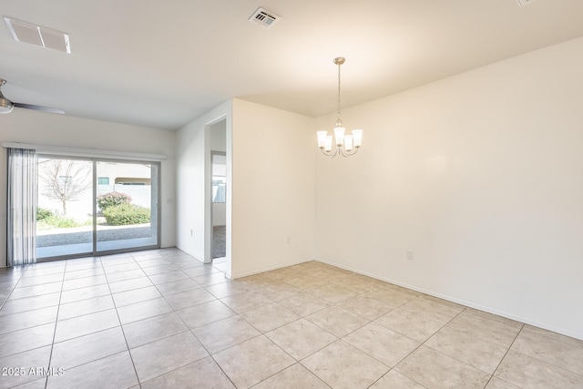 empty room with light tile patterned floors, visible vents, and ceiling fan with notable chandelier