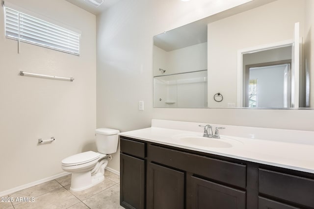 bathroom with vanity, tile patterned flooring, toilet, and baseboards