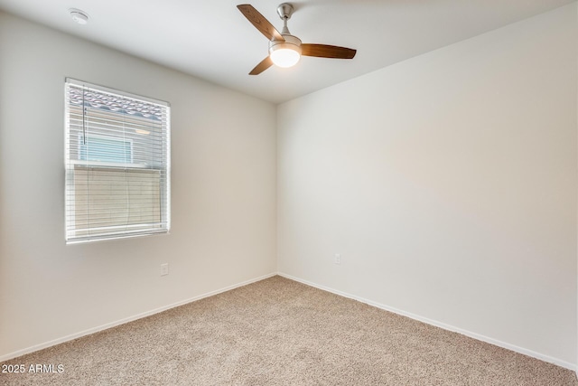 unfurnished room with light carpet, a ceiling fan, and baseboards