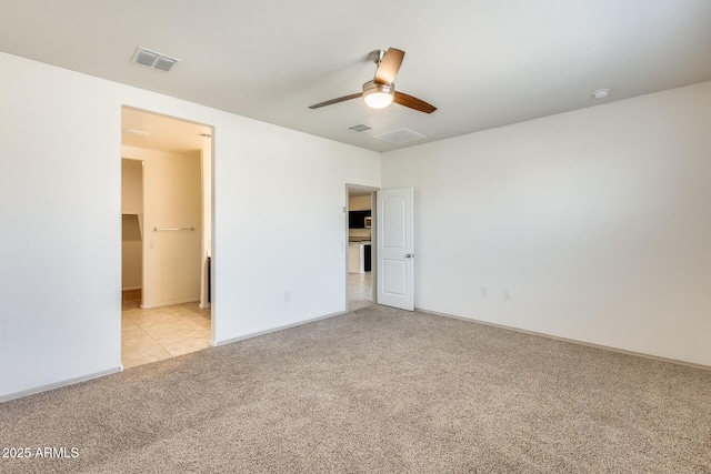 unfurnished bedroom featuring light carpet, ceiling fan, and visible vents